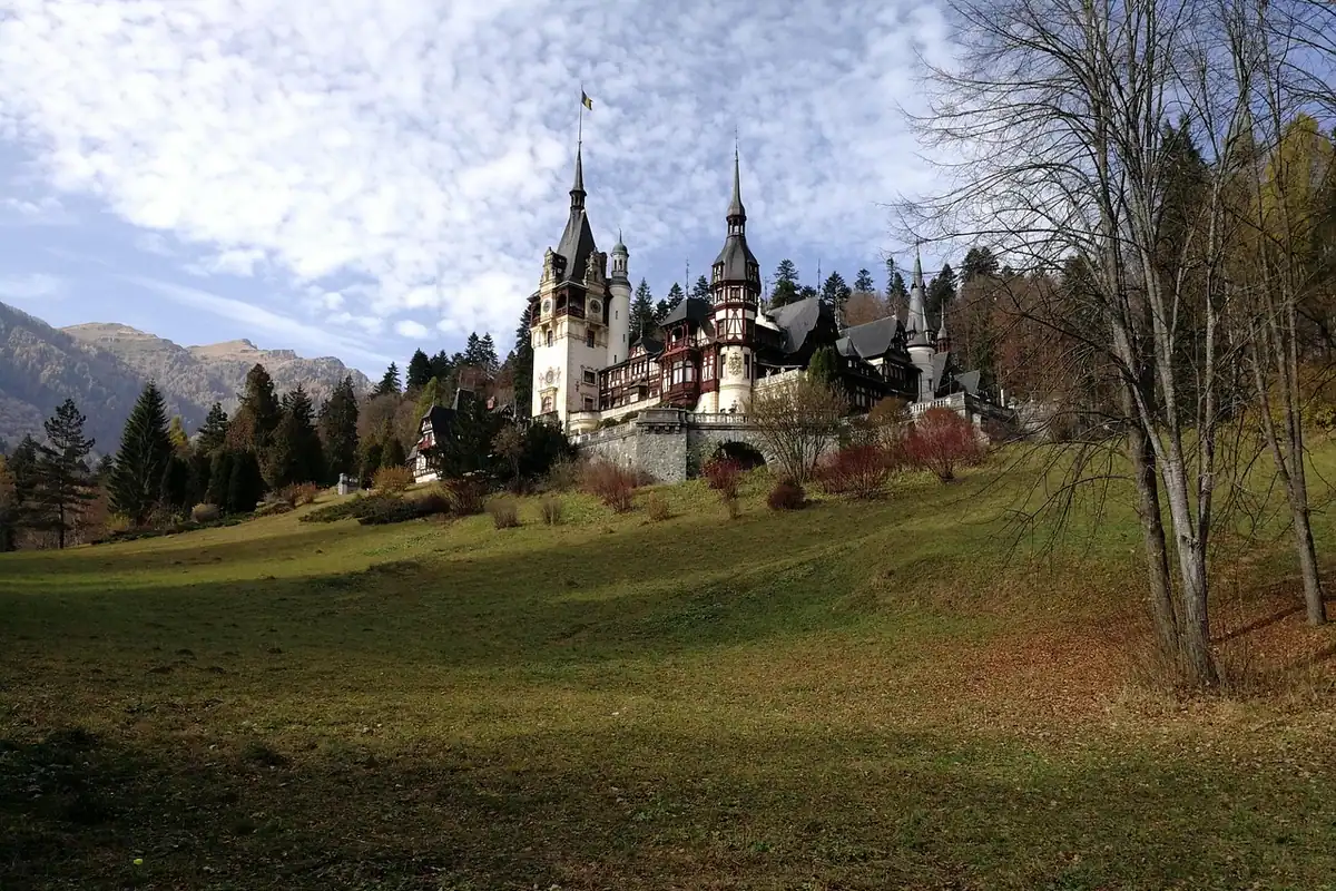Peleș și turnurile sale deasupra pajiștii de toamnă, în apropiere de Sinaia