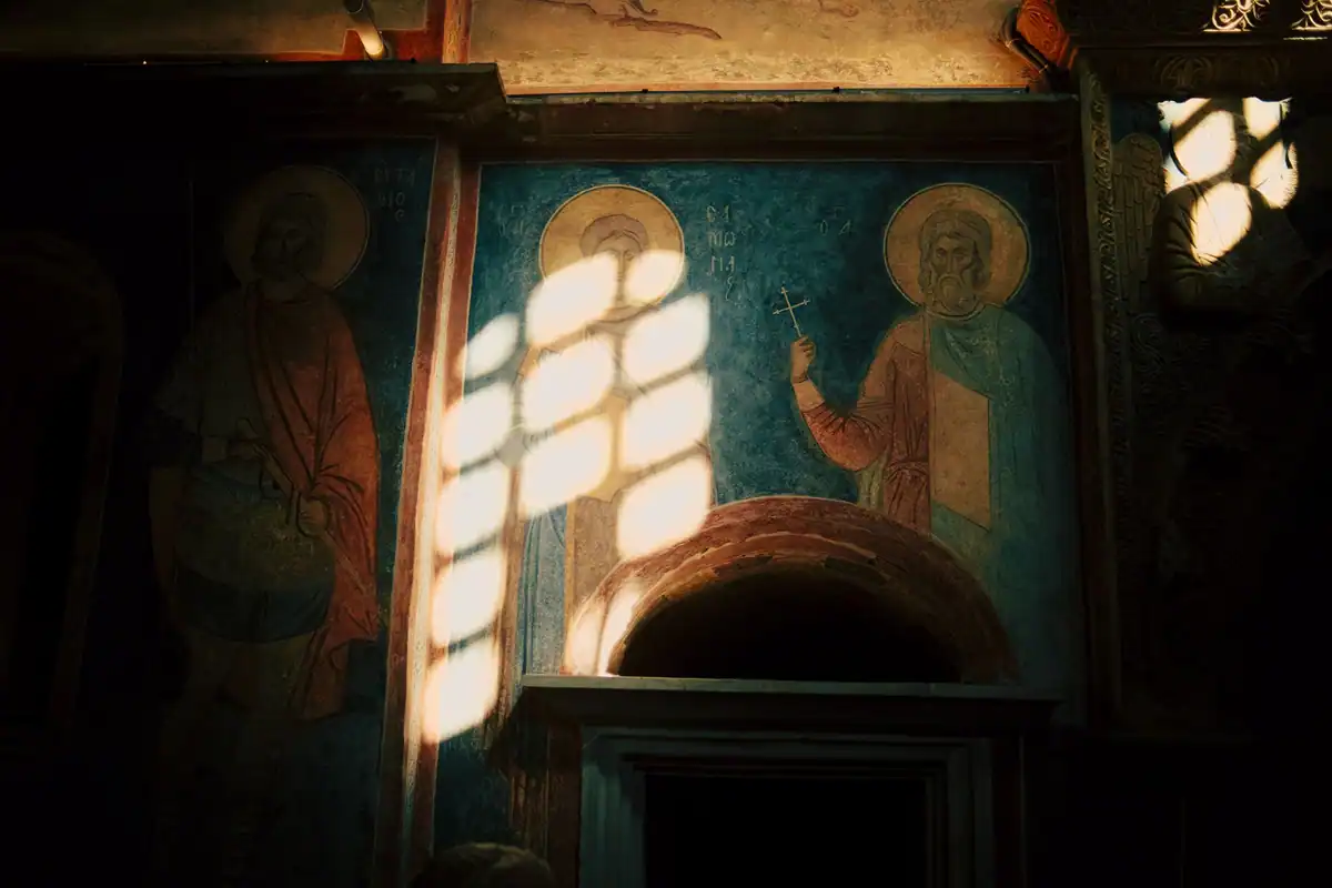 Fresce bizantine într-o biserică veche, luminate de raze de soare